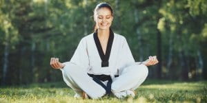 Martial Arts Lessons for Adults in Garner NC - Happy Woman Meditated Sitting Background